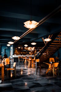 Elegant modern café with warm lighting and contemporary decor, creating a cozy atmosphere.