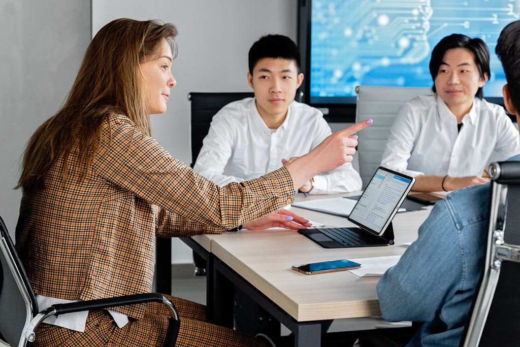 Professional team engaged in collaborative discussion in a modern office setting.