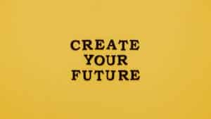 Bold text 'CREATE YOUR FUTURE' on minimalist yellow background. Inspiring design.