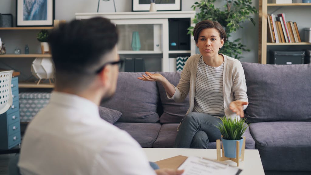 Photo by Vitaly Gariev A woman consulting with a professional therapist in a modern office setting.
